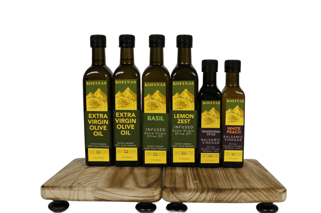 Six Kofinas olive oil and vinegar bottles arranged on a wooden stand