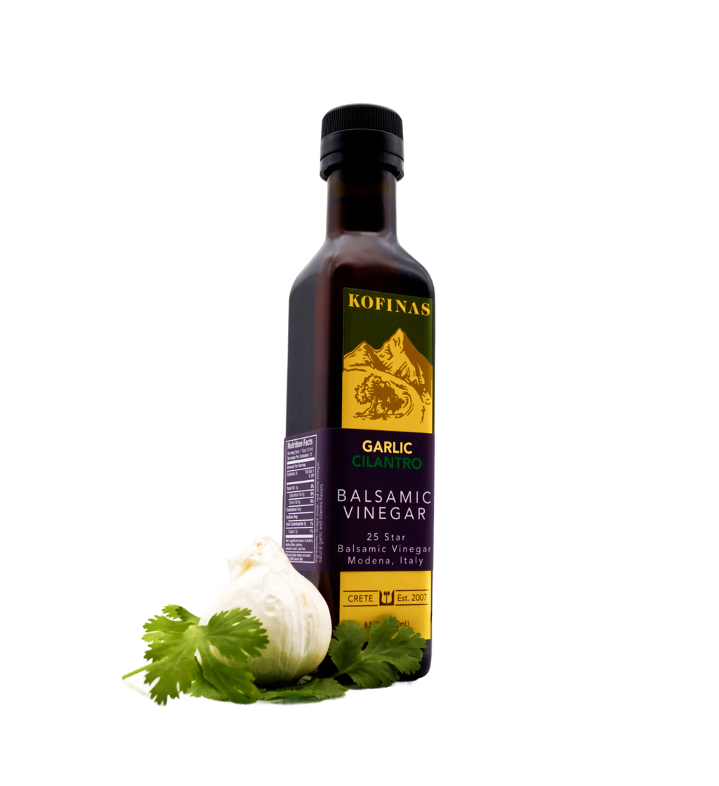Kofinas Garlic dark balsamic vinegar in a bottle with a garlic bulb and cilantro at the base