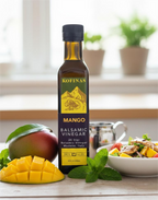 Kofinas Mango balsamic vinegar bottle with fresh mango slices and a fruit salad