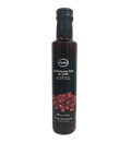Black bottle of Kofinas Greek balsamic vinegar with pomegranate and a pomegranate label
