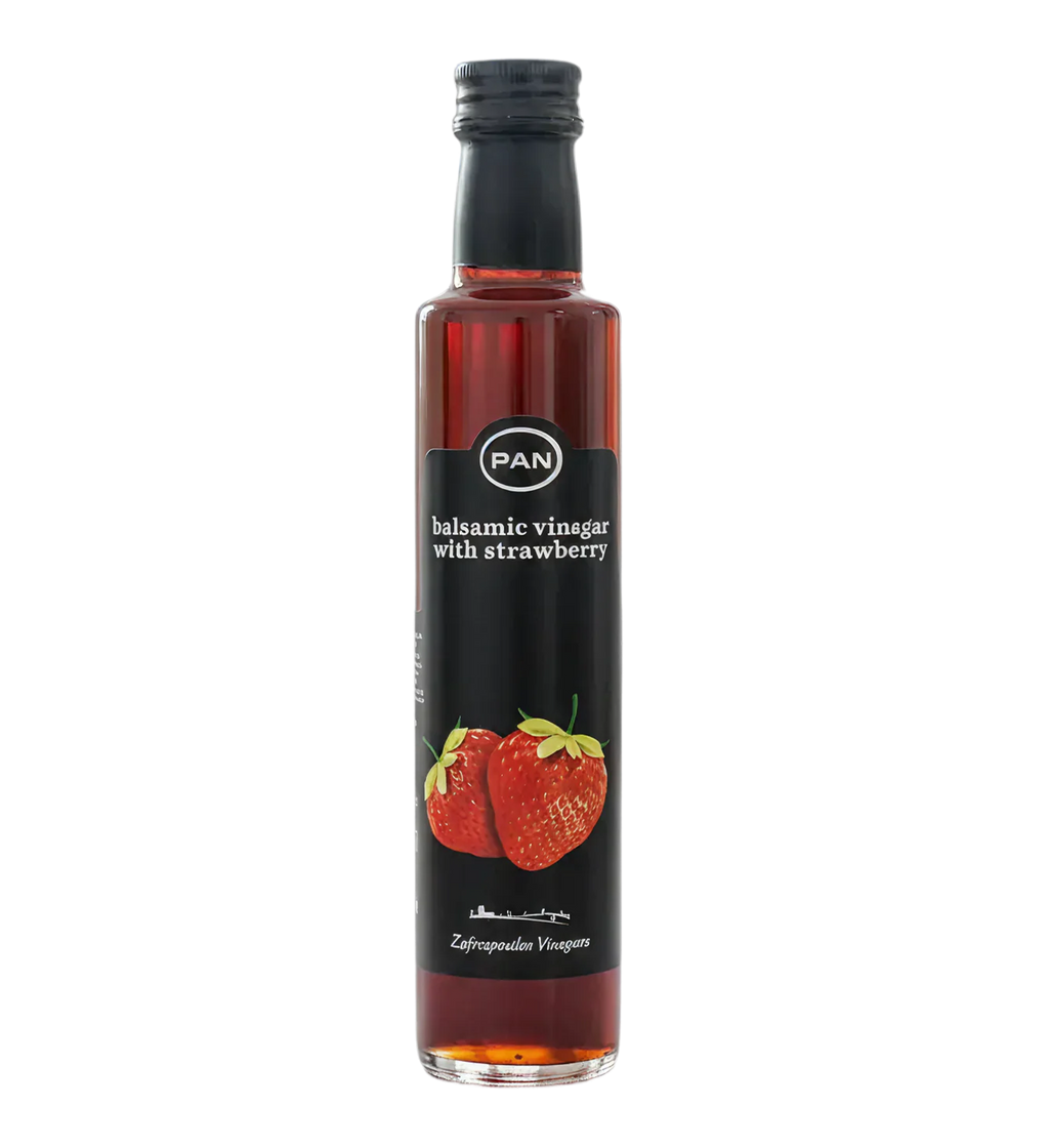 Black bottle of Greek balsamic vinegar with strawberry, with a strawberry on the label