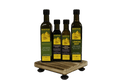 Four Kofinas infused olive oil bottles on a small wooden stand