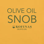 Close-up of a yellow-gold t-shirt printed with 'Olive Oil Snob' and the Kofinas logo
